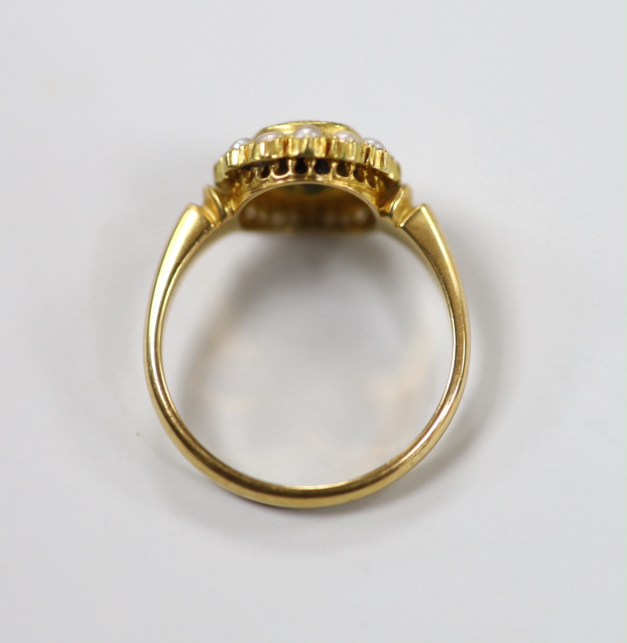 An Edwardian 18ct gold, green tourmaline and split pearl set oval cluster ring, size S, gross weight 6 grams.